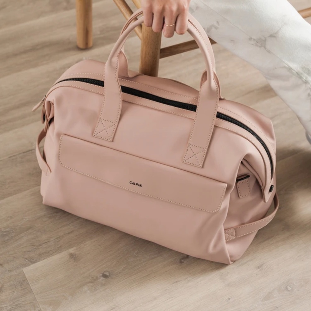 Used but in good condition! Calpak hue “pink sand” duffel bag!